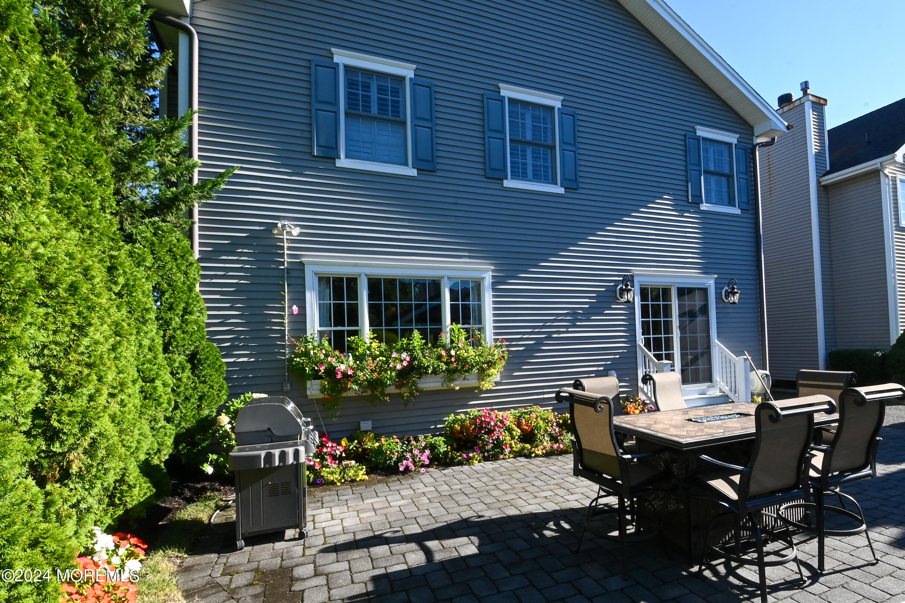 513 Mercer Avenue Spring Lake, NJ 07762 - Photo 8 of 53 a view of a backyard with table and chairs and potted plants