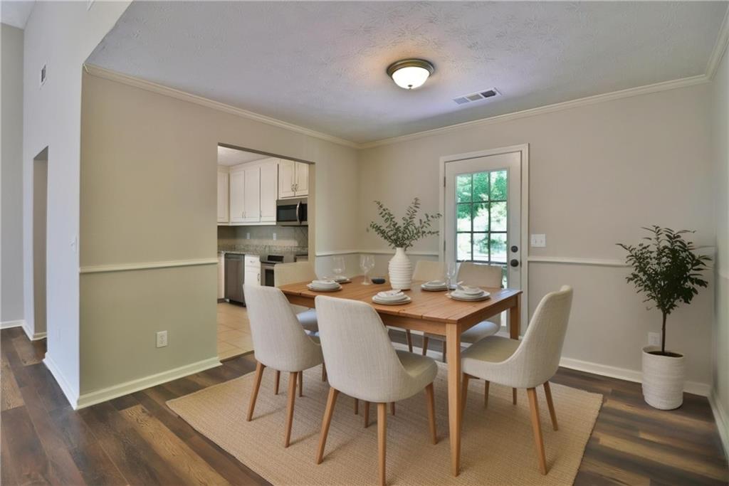 353 Fall View Court Winder, GA 30680 - Photo 29 of 61 a view of a dining room with furniture and wooden floor