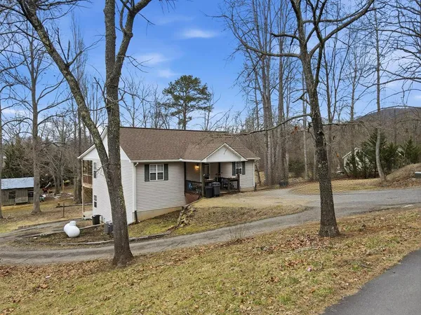 a view of a house with a tree in the background