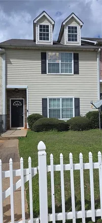 a front view of a house with a yard table and chairs