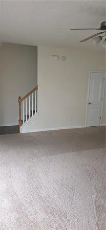 en empty room with windows and fireplace