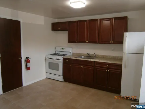 a kitchen with a sink and a refrigerator