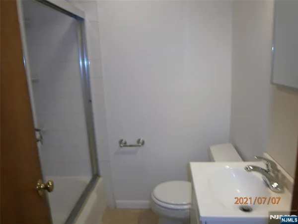 a white toilet sitting next to a shower