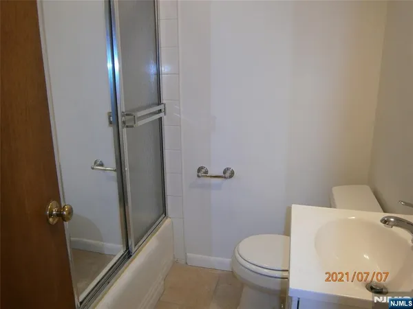 a white toilet sitting next to a shower