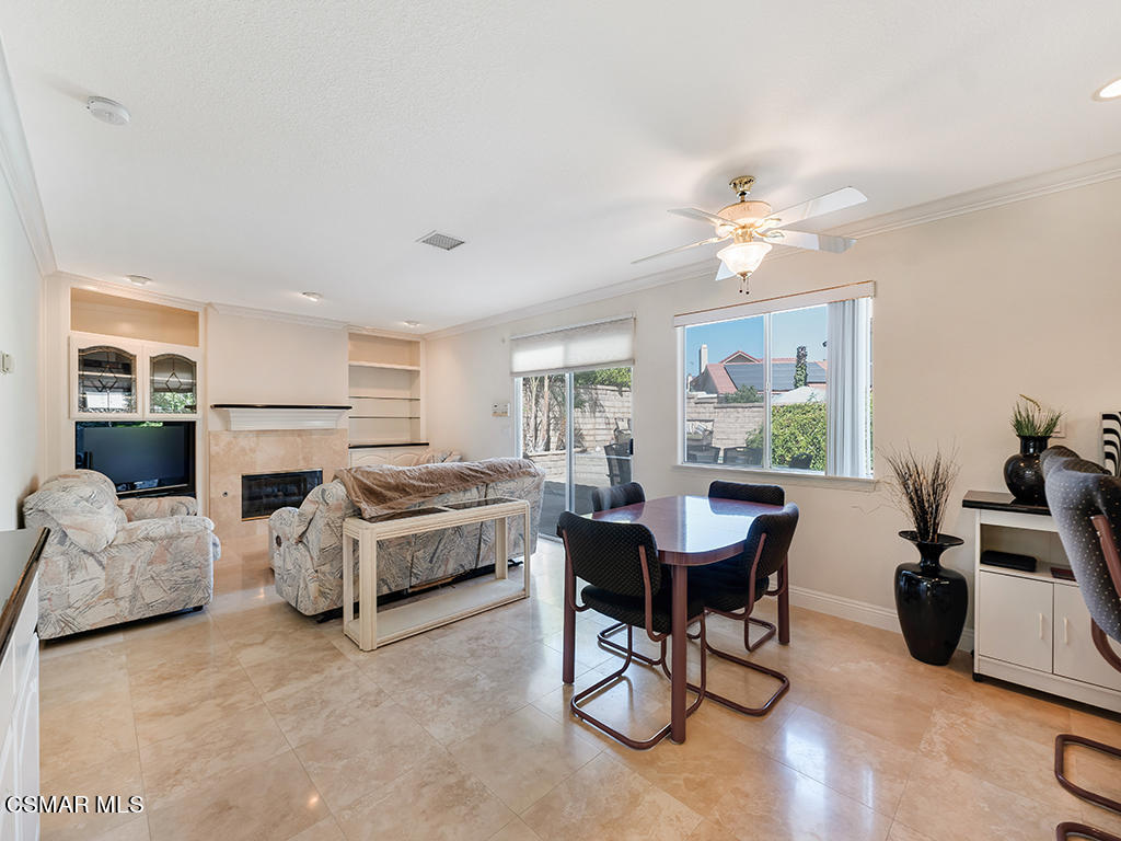 5218 Indian Hills Drive Simi Valley, CA 93063 - Photo 22 of 44 a living room with furniture a fireplace and a table