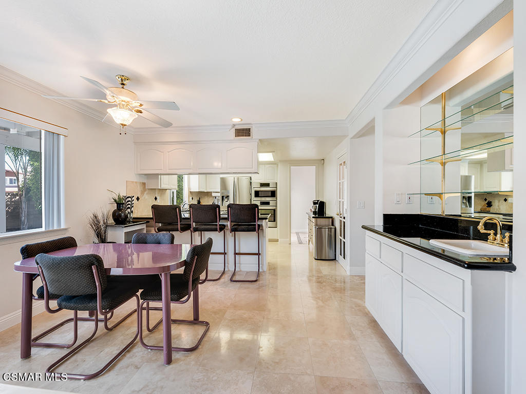 5218 Indian Hills Drive Simi Valley, CA 93063 - Photo 23 of 44 a kitchen with stainless steel appliances a stove a table and chairs