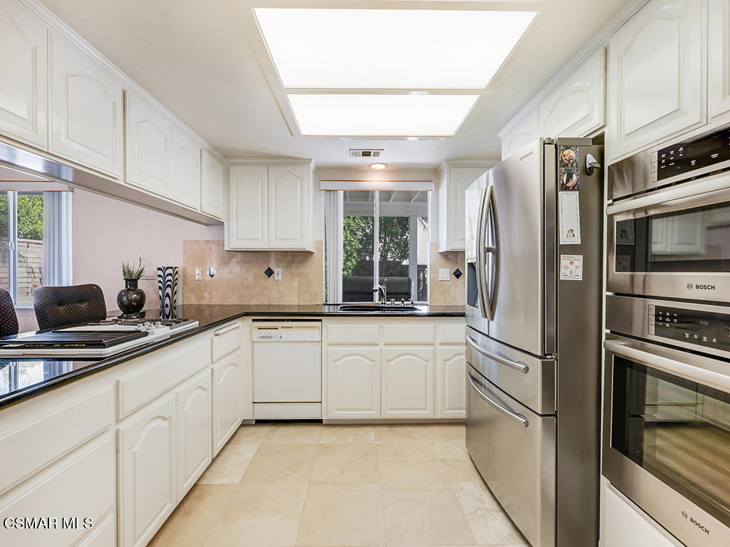 5218 Indian Hills Drive Simi Valley, CA 93063 - Photo 24 of 44 a kitchen with a refrigerator and cabinets