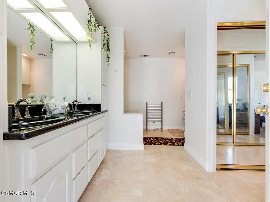 5218 Indian Hills Drive Simi Valley, CA 93063 - Photo 30 of 44 a bathroom with a double vanity sink and mirror