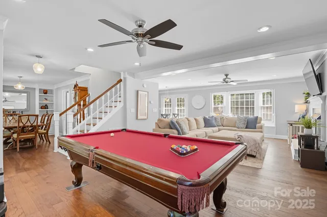 a room with pool table and windows