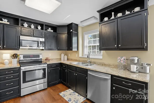 a kitchen with a sink stove and microwave