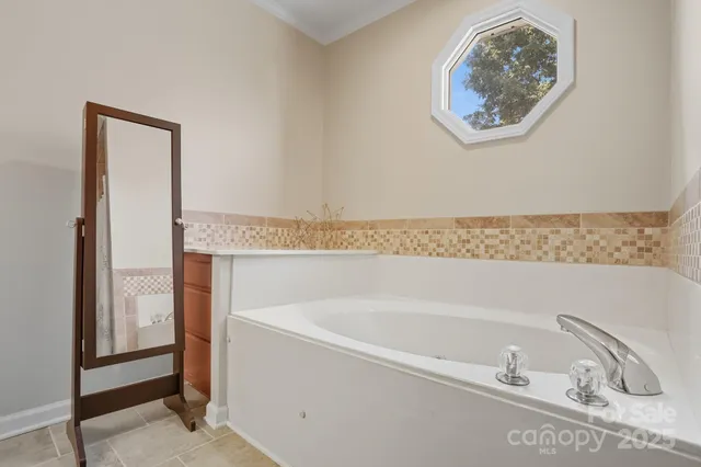 a bathroom with a bathtub and a window