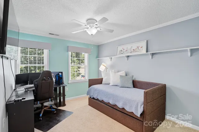 a bedroom with a bed furniture and windows