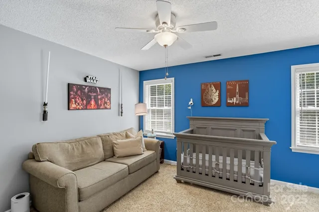 a bedroom with furniture and a window