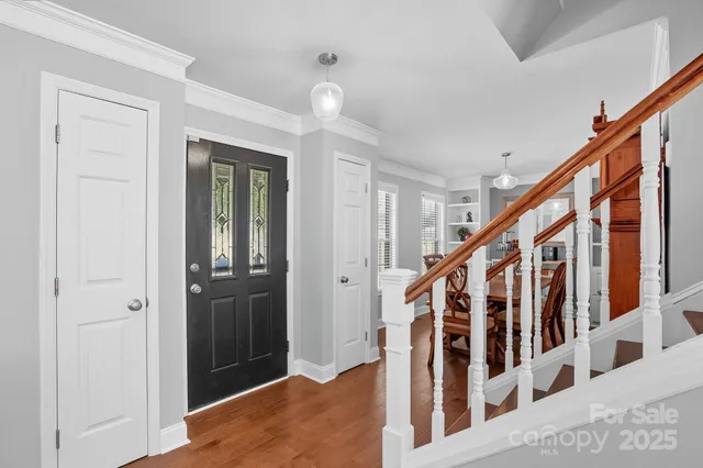 a view of staircase with lots of frames and door