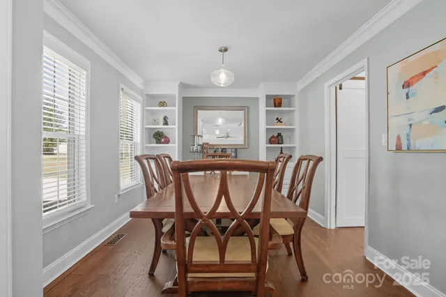 a view of a dining room with furniture and wooden floor