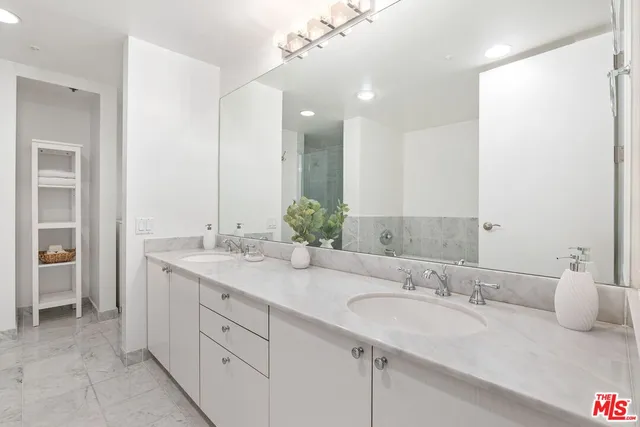 a bathroom with a double vanity sink mirror and double