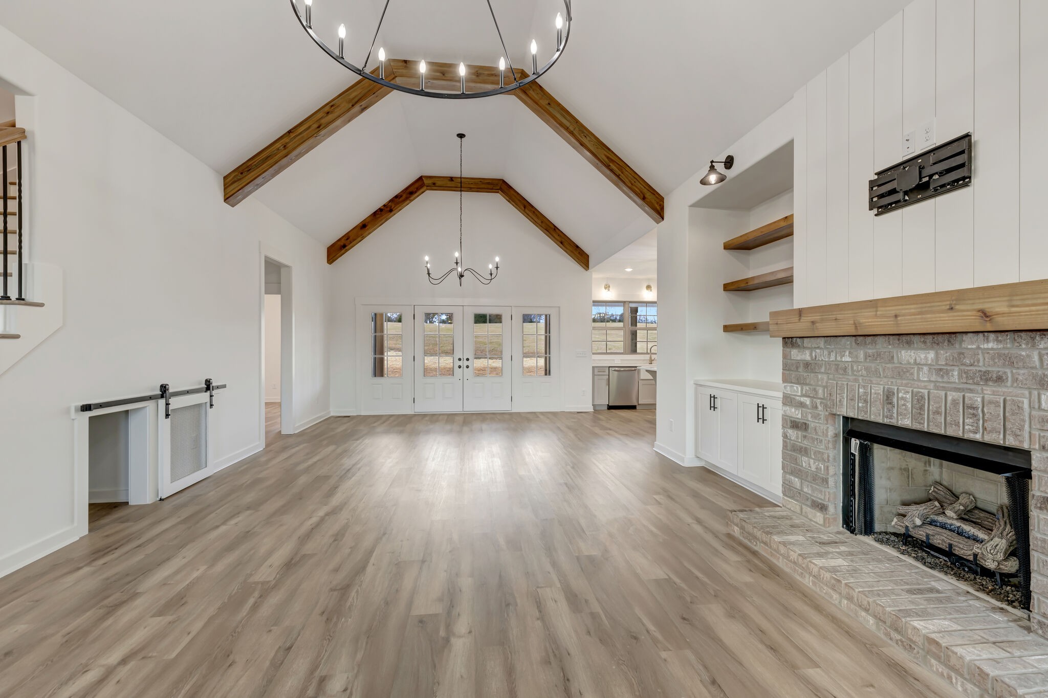 1 Hunter Bills Road Lewisburg, TN 37091 - Photo 12 of 48 an empty room with wooden floor fireplace and windows