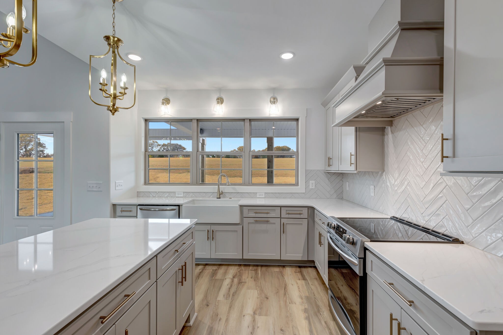 1 Hunter Bills Road Lewisburg, TN 37091 - Photo 19 of 48 a kitchen with a sink dishwasher a stove and white cabinets with wooden floor