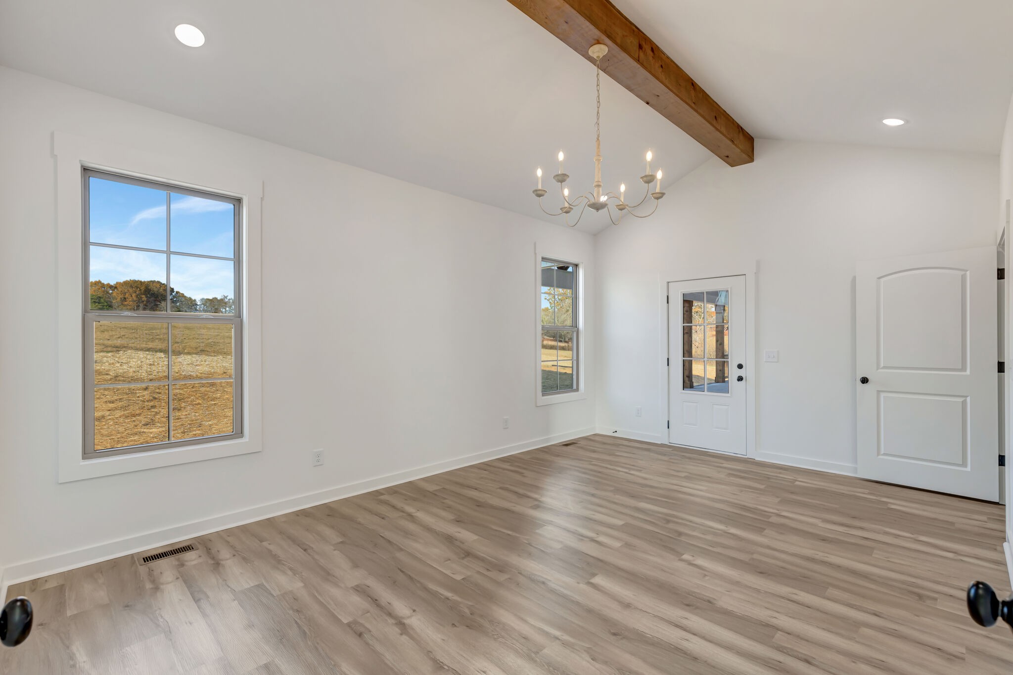 1 Hunter Bills Road Lewisburg, TN 37091 - Photo 27 of 48 an empty room with wooden floor chandelier and windows