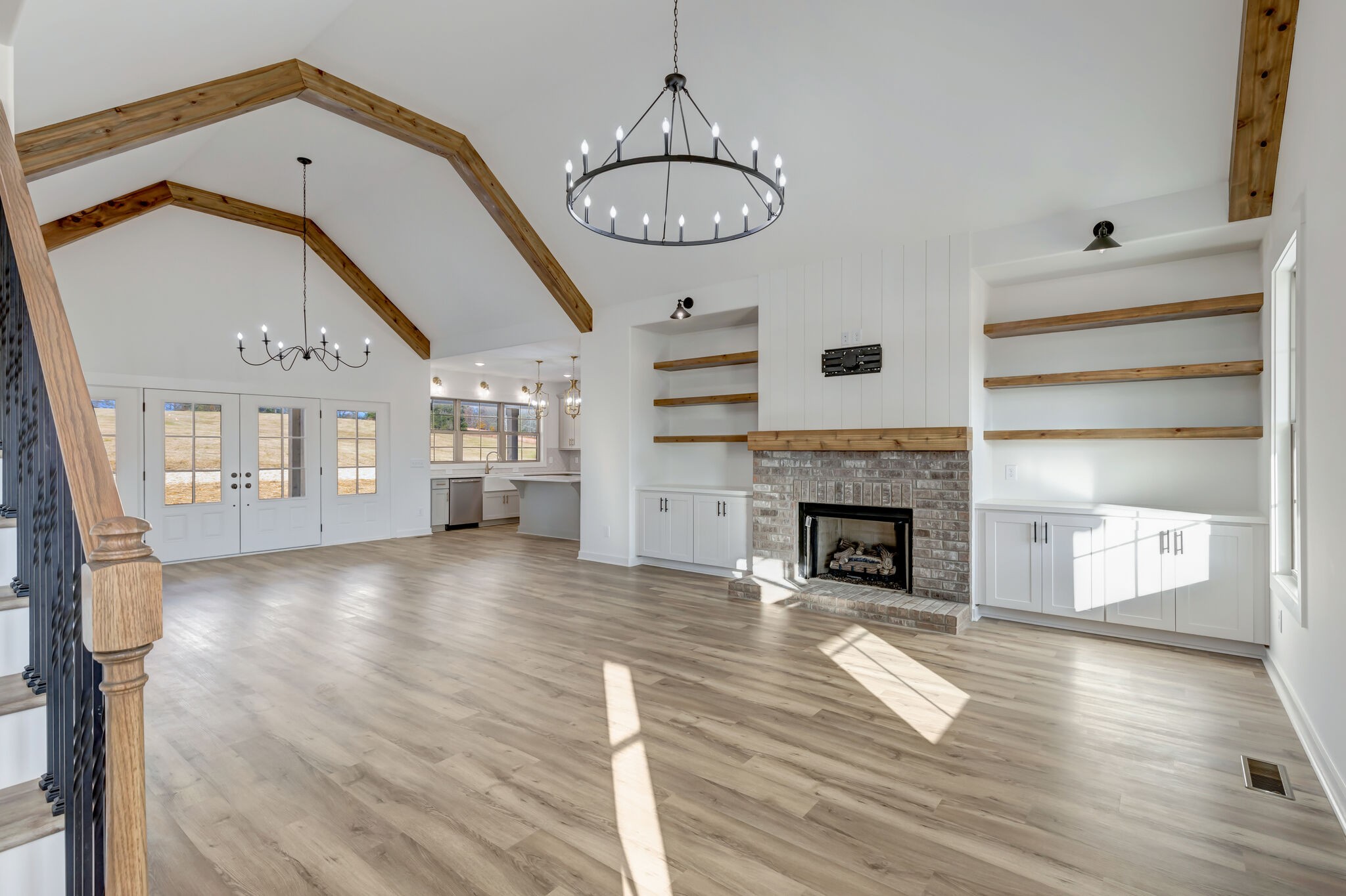 1 Hunter Bills Road Lewisburg, TN 37091 - Photo 9 of 48 a view of a livingroom with a fireplace a chandelier and wooden floor