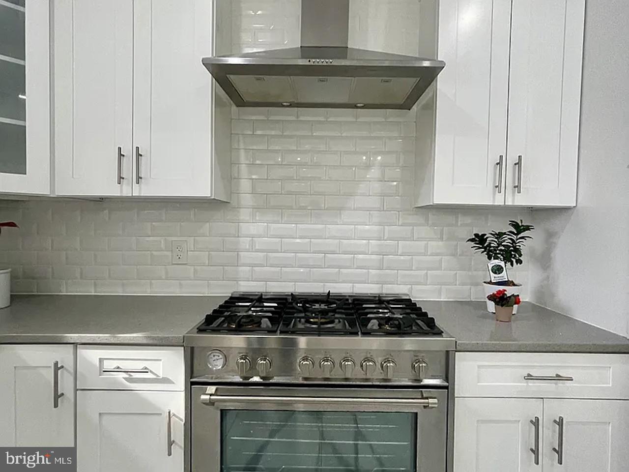 8618 Jones Mill Road Chevy Chase, MD 20815 - Photo 17 of 59 a kitchen with a stove and white cabinets