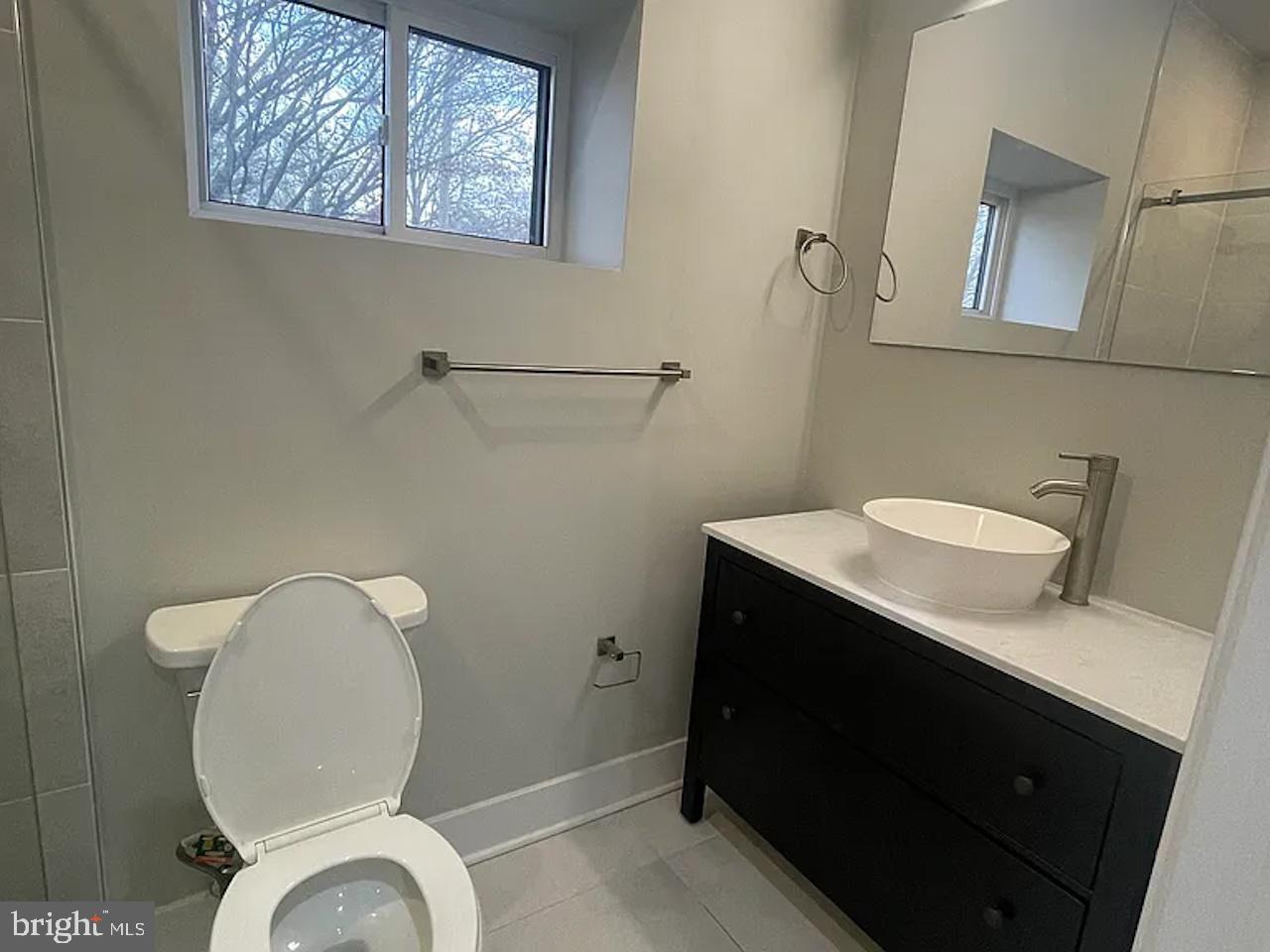 8618 Jones Mill Road Chevy Chase, MD 20815 - Photo 22 of 59 a bathroom with a toilet sink and mirror