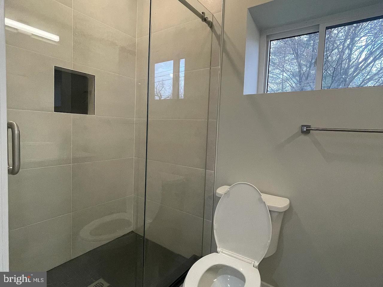 8618 Jones Mill Road Chevy Chase, MD 20815 - Photo 23 of 59 a bathroom with a toilet and a mirror