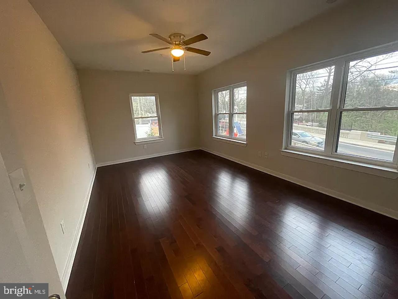 8618 Jones Mill Road Chevy Chase, MD 20815 - Photo 35 of 59 an empty room with wooden floor and windows