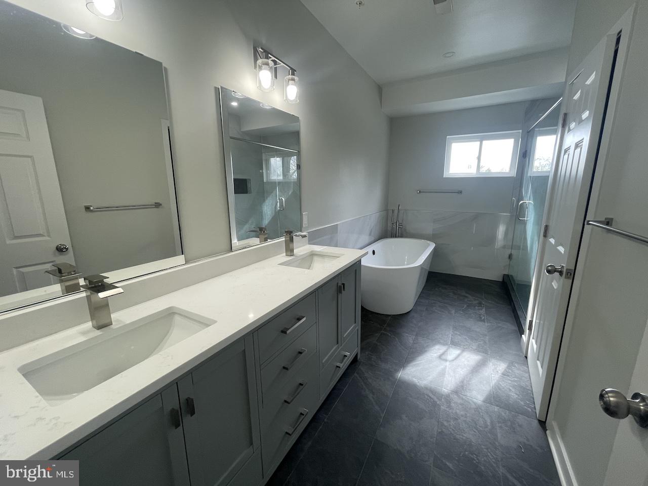 8618 Jones Mill Road Chevy Chase, MD 20815 - Photo 42 of 59 a bathroom with a double vanity sink double mirror and toilet