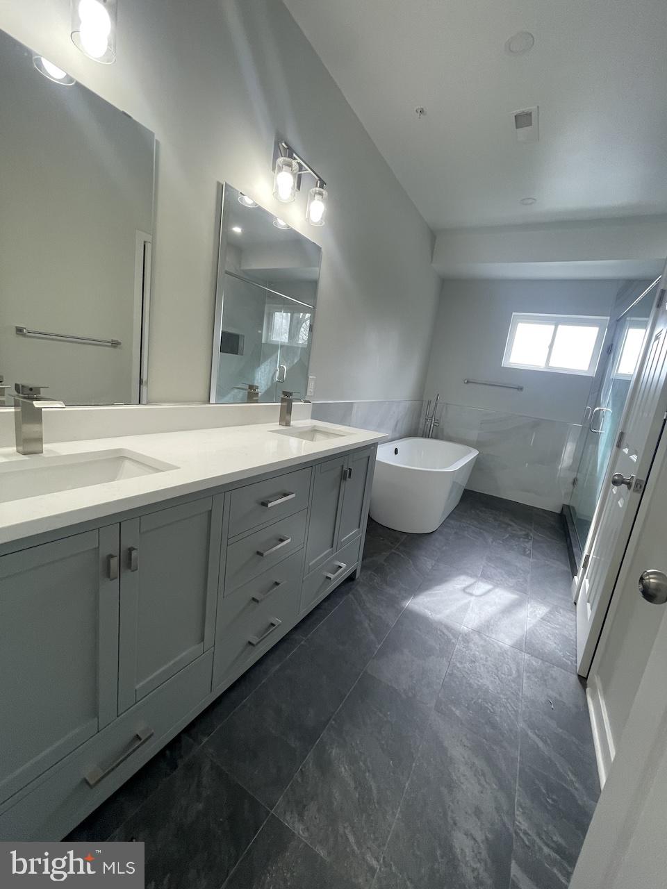 8618 Jones Mill Road Chevy Chase, MD 20815 - Photo 43 of 59 a bathroom with a double vanity sink and a mirror