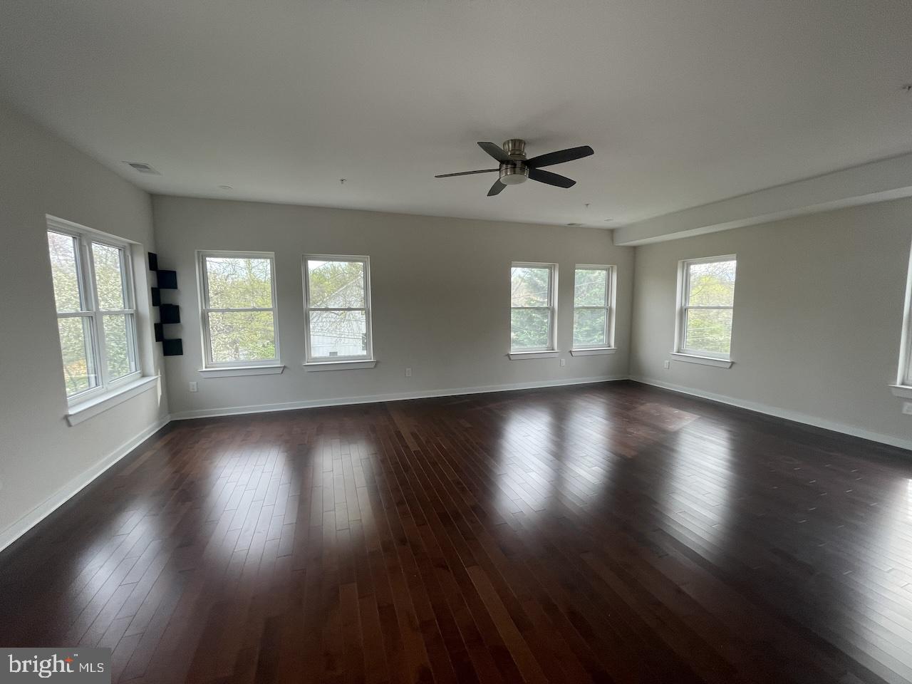 8618 Jones Mill Road Chevy Chase, MD 20815 - Photo 47 of 59 a view of an empty room with wooden floor and a window