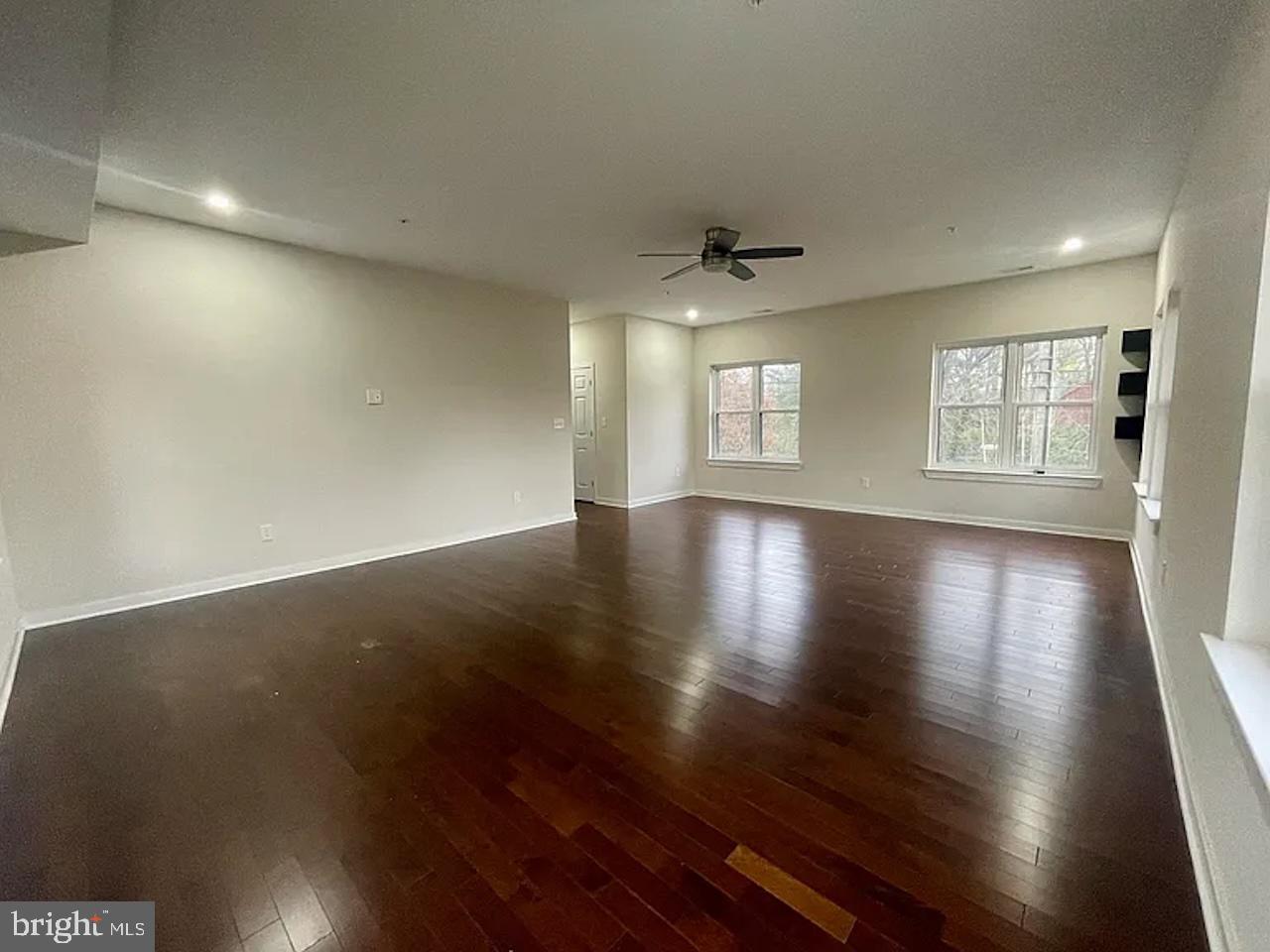 8618 Jones Mill Road Chevy Chase, MD 20815 - Photo 48 of 59 an empty room with wooden floor and windows