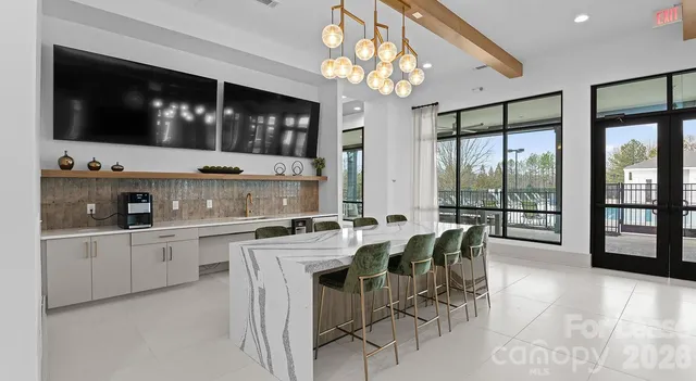 a large kitchen with a table and chairs