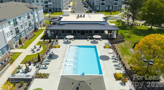 a view of swimming pool with outdoor seating and yard