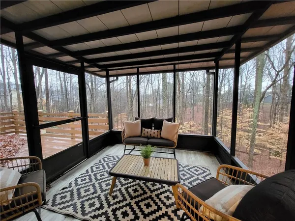a living room with furniture and a floor to ceiling window