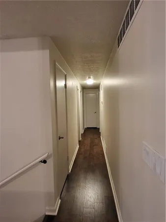 a view of hallway with wooden floor