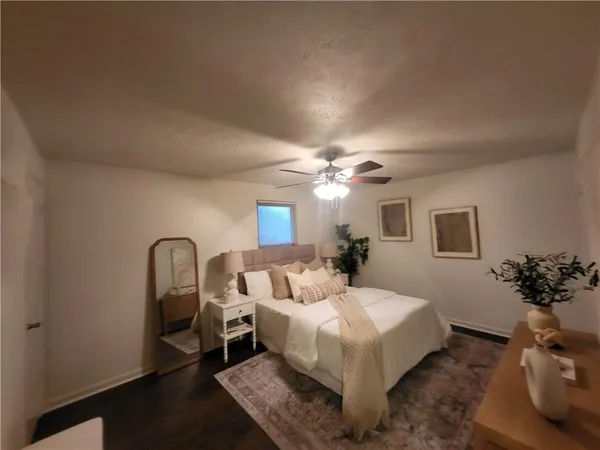 a living room with furniture flowerpot and a chandelier