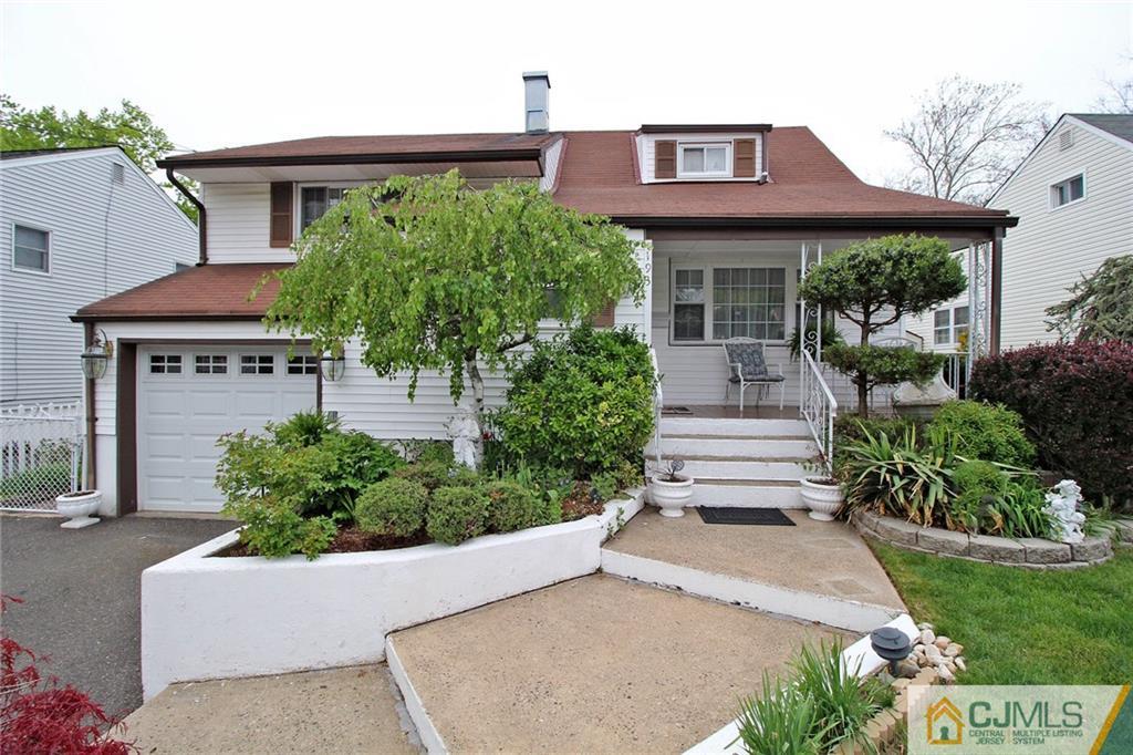 a front view of a house with a yard and potted plants