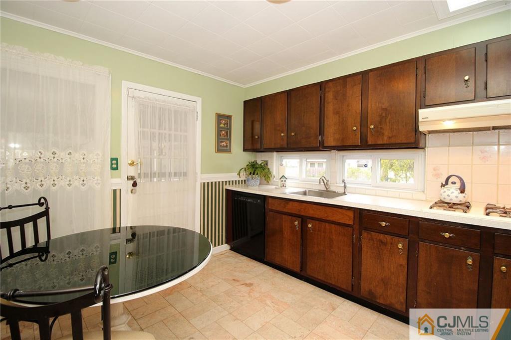 193 McFarlane Road Colonia, NJ 07067 - Photo 13 of 25 a kitchen with a sink cabinets and window