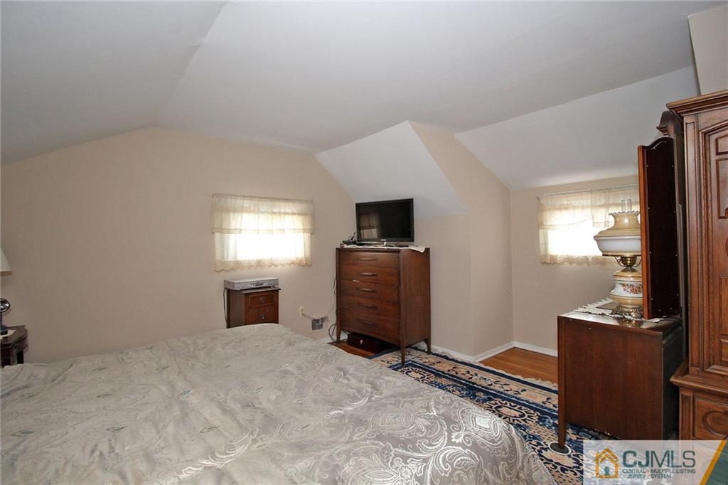 193 McFarlane Road Colonia, NJ 07067 - Photo 20 of 25 a bedroom with a bed and a television