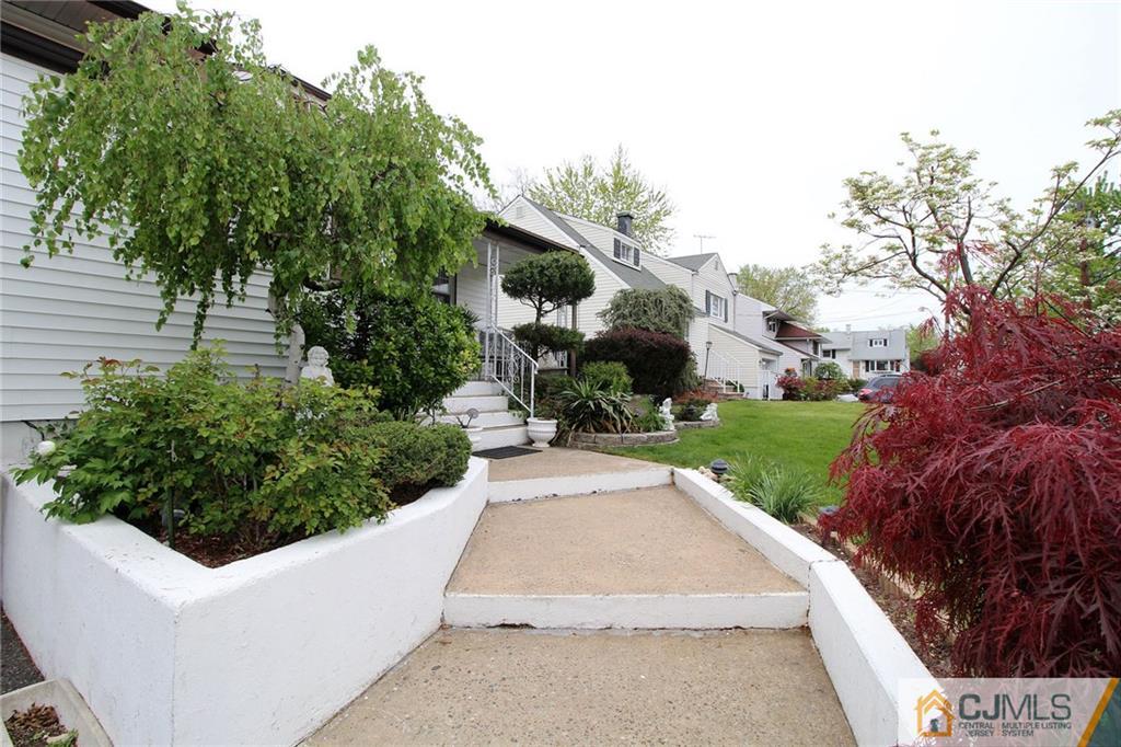 193 McFarlane Road Colonia, NJ 07067 - Photo 3 of 25 a view of a white house with a yard