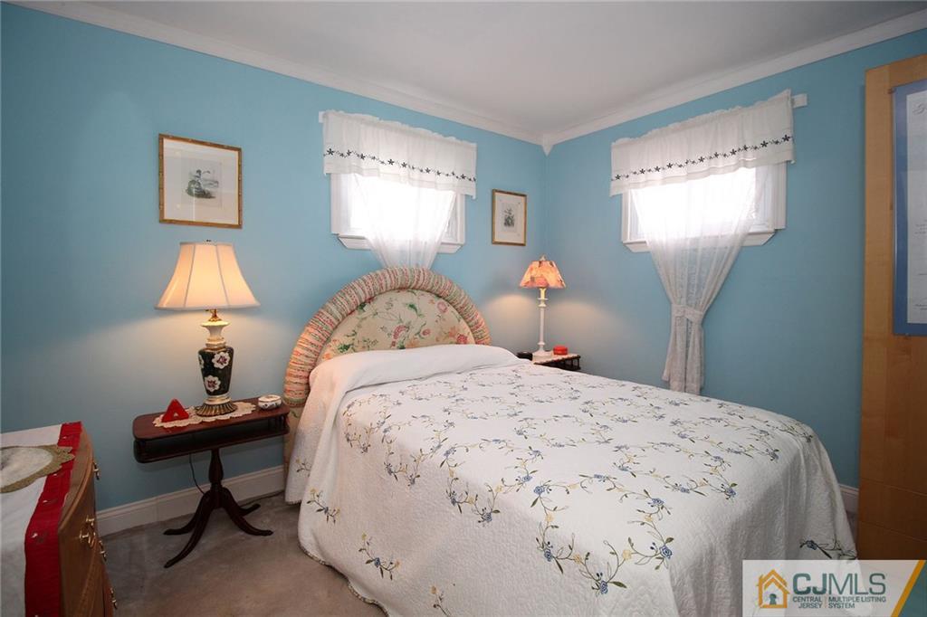 193 McFarlane Road Colonia, NJ 07067 - Photo 22 of 25 a bedroom with a bed and a lamp on dresser