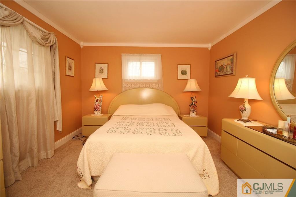 193 McFarlane Road Colonia, NJ 07067 - Photo 23 of 25 a spacious bedroom with a bed and wooden floor