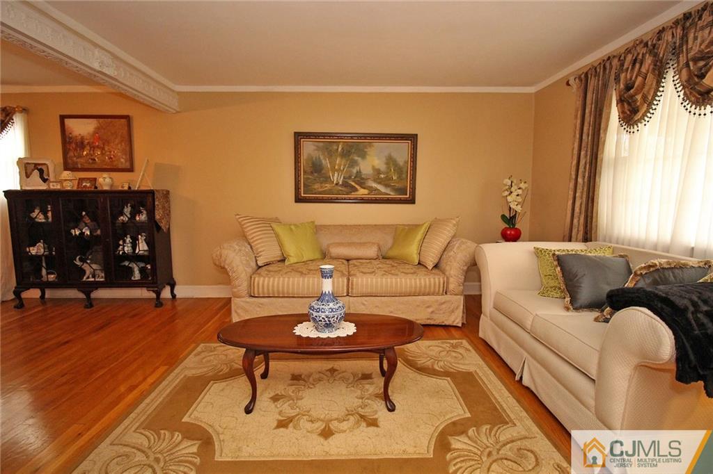 193 McFarlane Road Colonia, NJ 07067 - Photo 7 of 25 a living room with furniture and painting on the wall