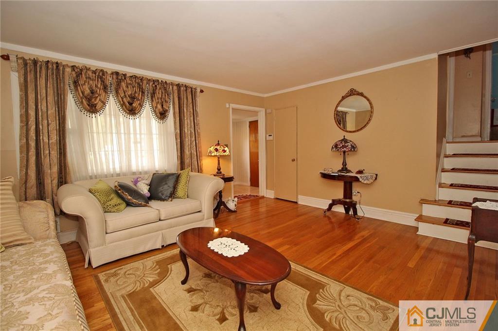 193 McFarlane Road Colonia, NJ 07067 - Photo 8 of 25 a living room with furniture and a chandelier