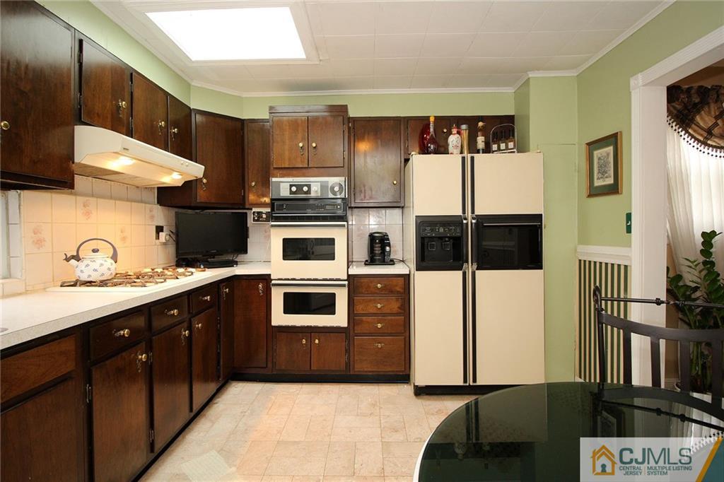 193 McFarlane Road Colonia, NJ 07067 - Photo 10 of 25 a kitchen with stainless steel appliances kitchen island granite countertop a refrigerator and a stove top oven