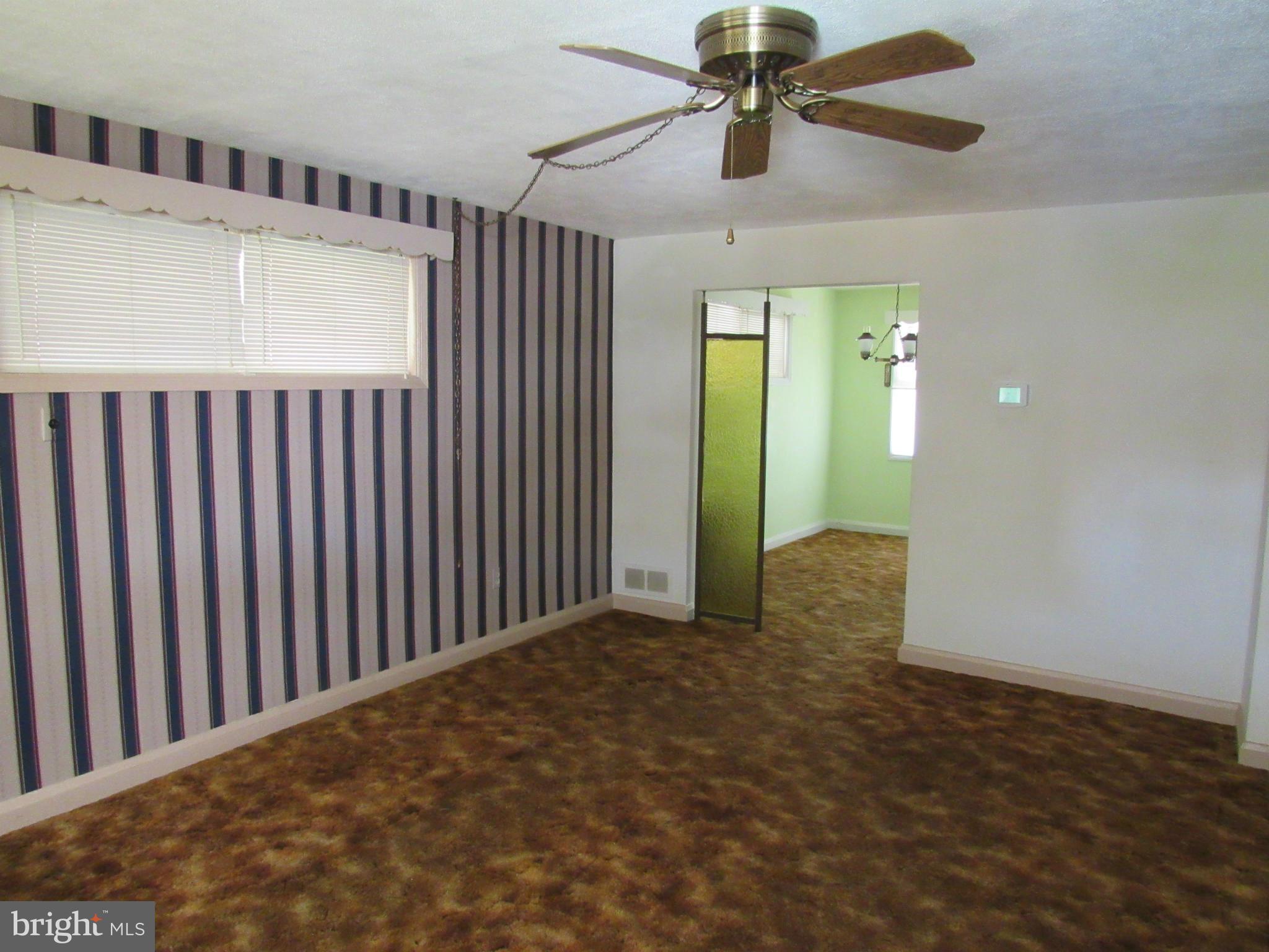 1912 Haselmere Road Baltimore, MD 21222 - Photo 3 of 29 a view of a hallway with a chandelier fan and windows