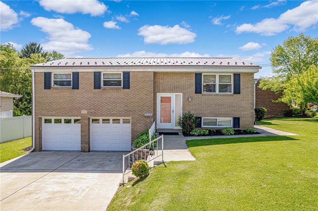 a view of a house with a swimming pool and a yard