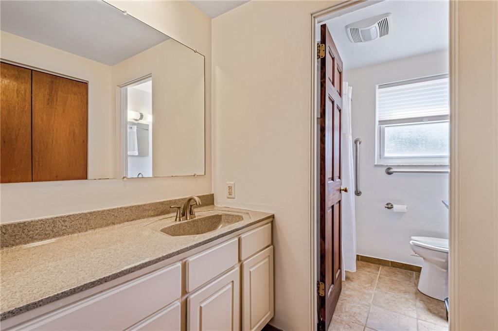5000 Homeville Road West Mifflin, PA 15122 - Photo 11 of 24 a bathroom with a sink a toilet and a large mirror