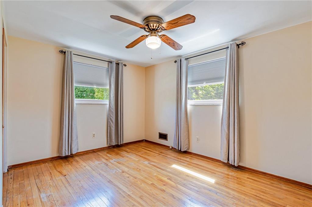 5000 Homeville Road West Mifflin, PA 15122 - Photo 13 of 24 an empty room with wooden floor chandelier fan and windows